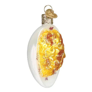Deviled Egg Ornament, white egg-shaped glass ornament with yellow yolk and gold glitter accents, hanging loop