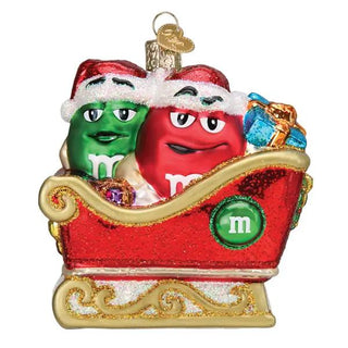 M&M's In Sleigh Ornament featuring two glittery red and green candy characters in a gold-trimmed red sleigh