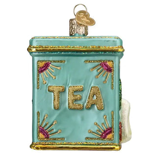 Tea tin ornament in turquoise with gold trim, glitter accents, and TEA lettering.