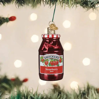 Strawberry jam ornament in a red glass jar with a silver lid, hung on a Christmas tree