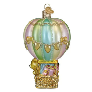 Baby bear balloon ornament with pastel striped balloon, gold trim, and wicker basket.