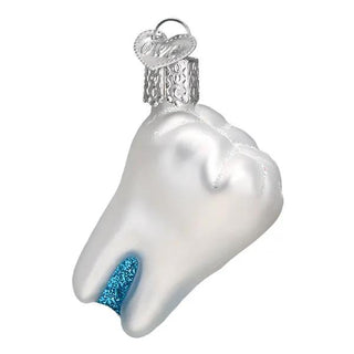 Tooth-shaped ornament with pearlescent white finish, blue glitter at the root, and a silver cap with heart charm.