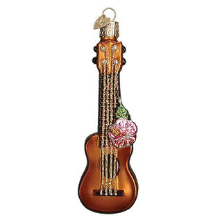 Ukulele ornament, brown glass with gold-toned strings and pink hibiscus accent