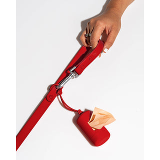 Poop Bag Carrier Dispenser for Pets and Dogs, red, attached to a red leash with metal clip