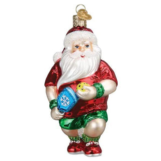 Pickleball Santa ornament in red shirt and green shorts, holding a yellow ball and blue paddle.