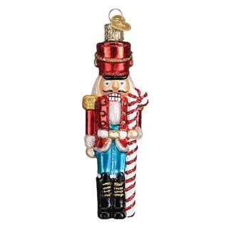 Peppermint nutcracker ornament, red jacket with gold trim, blue pants, black boots, holding a striped candy cane