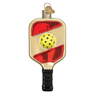 Pickleball paddle ornament: gold paddle with red enamel accents, yellow ball, black handle.