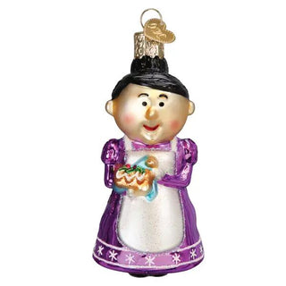 Cheery Mrs. Claus ornament in a purple dress with white apron, holding an orange pumpkin.