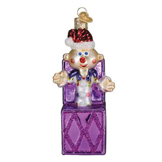 Charlie in the Box clown ornament with purple diamond-pattern gift box and glitter accents