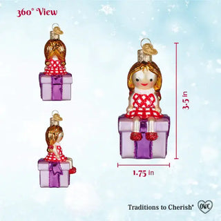 Misfit Doll Ornament on a purple gift box, shown in 3 views, with a red-and-white check dress, 3.5in tall.