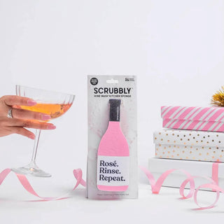 Scrubbly kitchen sponge in pink bottle-shaped packaging with Rosé Rinse Repeat branding