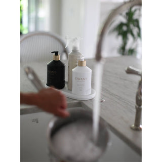 Fresh Linen High Performing Dish Soap set on marble counter; white, black, and clear spray bottles.