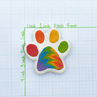 Pride Paw paw-shaped pet treat with rainbow swirl center and colorful toe beans.
