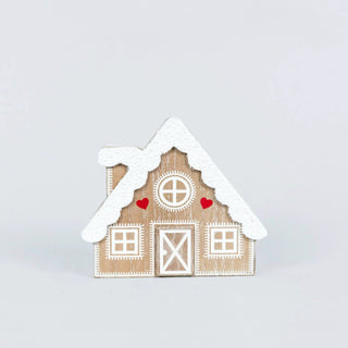 Wooden cabin-shaped Christmas decor with snow-dusted roof, white decorative windows, and red heart accents