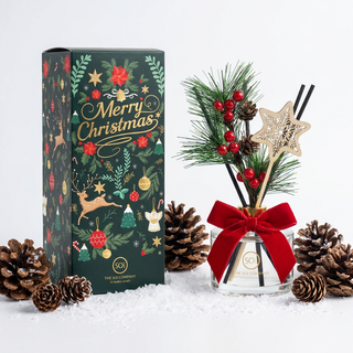 Reed diffuser Pine Cone Snowflake Holiday 6.9oz with SOi glass, red ribbon, evergreen sprigs, Merry Christmas box.