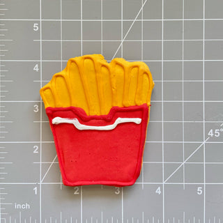Lunch Menu Dapper fry-shaped cookie in red carton with yellow fries and white sauce stripe