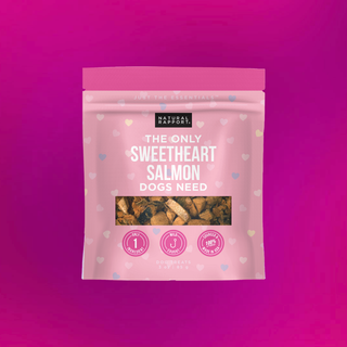 The Only Sweetheart Salmon Dogs Need dog treats in a pink bag with heart pattern.
