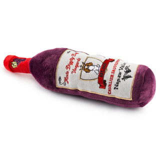 Cavalier Sauvignon dog toy, plush wine-bottle squeaker with purple body and red neck.