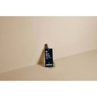 Dog chew made from natural sheep horn with a dark tag, displayed upright