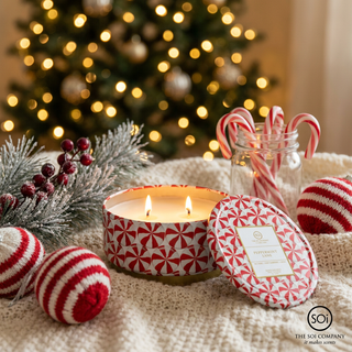 Peppermint Lane embossed Luxe 12oz tin 2-wick holiday candle in red-and-white peppermint pattern