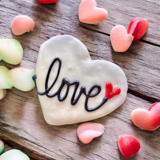 Classic Love heart dog treats, white heart cookie with black script and red heart accent.