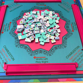 Lunaflor Mahjong Mat with turquoise playing surface, pink frame, and mint tiles.