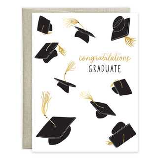 Graduation greeting card featuring floating black graduation caps with gold tassels