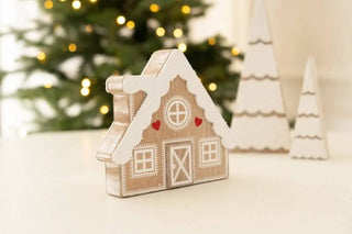 Wooden 6x5 chunky cabin Christmas decor in beige with white trim; two white decorative trees in background
