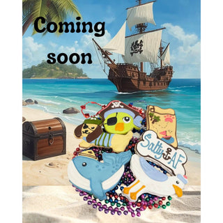 Sailor Whale dog treats on a sunny beach with treasure chest and pirate ship backdrop