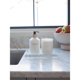 Lucite tray (medium) on a marble countertop holding two items: a pump bottle and a frosted candle.