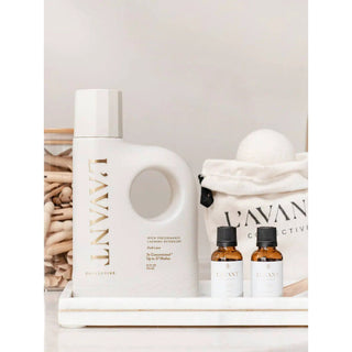 Laundry detergent Fresh Linen bottle with built-in handle and gold lettering, plus two small bottles on a white tray