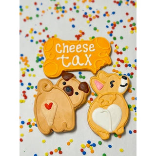 Snack Tariff Cookie three dog-shaped cookies with an orange bone-shaped piece and colorful sprinkles