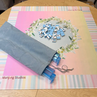 Mahjong rack storage bag, gray fabric with drawstring; fits 17.5–20 in racks; several blue tile racks extend from end.