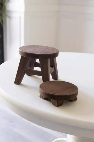 Round mini wood risers in espresso finish; set of two on a white table.