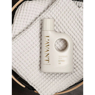 Laundry detergent bottle, Fresh Linen scent; white plastic with a circular handle and gold lettering.