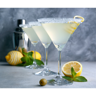 Natural Lemon Burst Wine Slushy Mix in three martini cocktails with sugared rims, lemon wedges, and mint.