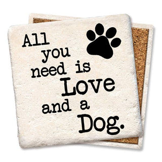 Two cream coasters with black typography reading All You Need Is Love and a Dog and a paw print, cork backs