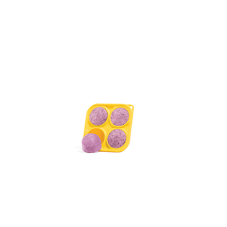 Pupsicle Treat Mix Calming mold with four purple discs and one loose purple ball in a yellow silicone tray