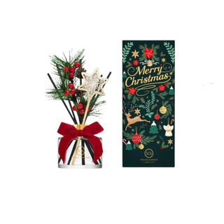 Reed diffuser set with a striped black-and-white bottle tied in red ribbon and holiday pine decorations, 6.9oz