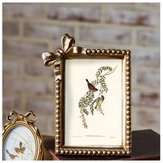 Antique gold bow frame with beaded edge featuring a botanical print of birds; two frames shown.