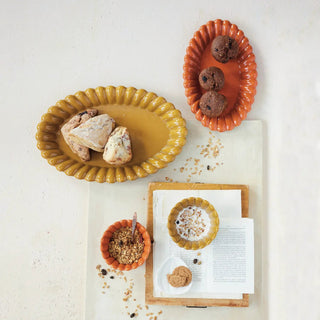Stoneware pumpkin-shaped dish pair in amber and orange tones