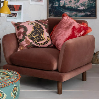 Pink cotton slub 20-inch square pillow with tiger and floral embroidery; paired with a red velvet accent pillow.