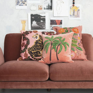 Pillow, 20in square cotton slub with embroidered tiger and flowers; part of a 3-pillow pink set on a sofa.