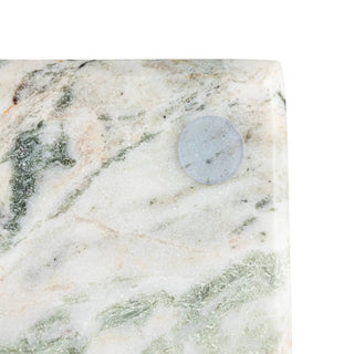 Marble cheese cutting board with canape knife on white marble with green veining