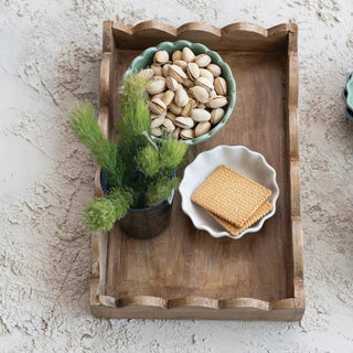Mango Wood Scalloped Tray, natural finish; serveware with a green scalloped bowl of pistachios.