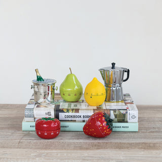 Plastic lemon-shaped 1-hour twist timer, yellow, displayed among colorful kitchen accessories.
