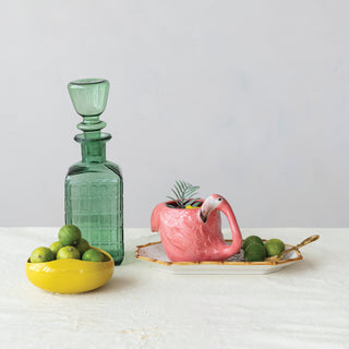 Flamingo-shaped mug, 14 oz, pink hand-painted stoneware, on a tray with a green decanter and a bowl of limes.