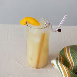 9 oz. Peach Jam in a tall glass with a peach slice garnish.