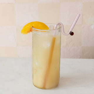 9 oz. Peach Jam tall glass with peach-colored beverage, peach slice garnish, and curved straw