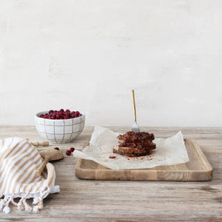 Cranberry chutney, 10 oz, red and glossy, served on parchment with crusty bread on a wooden board